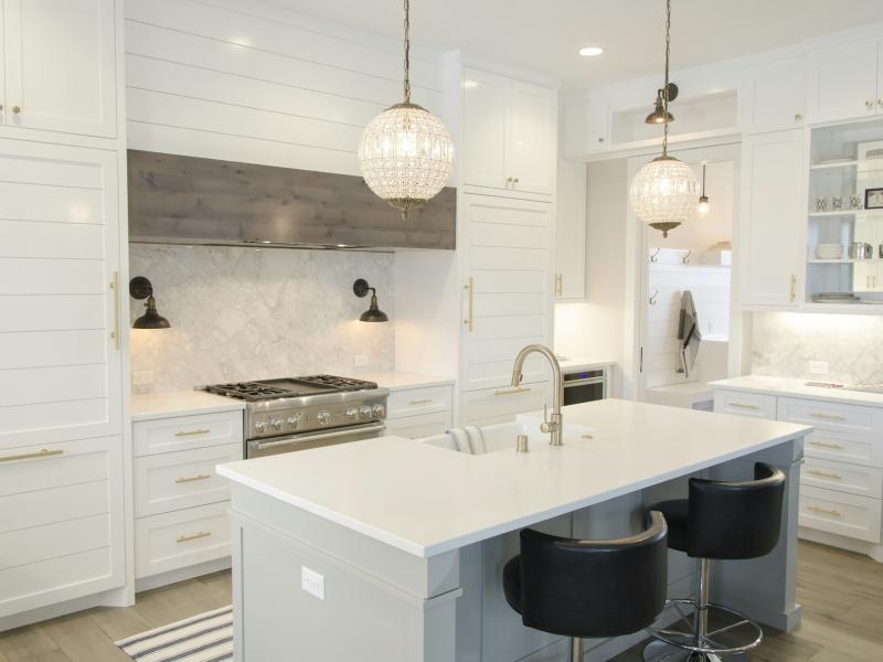White kitchen with an island and pendant lights